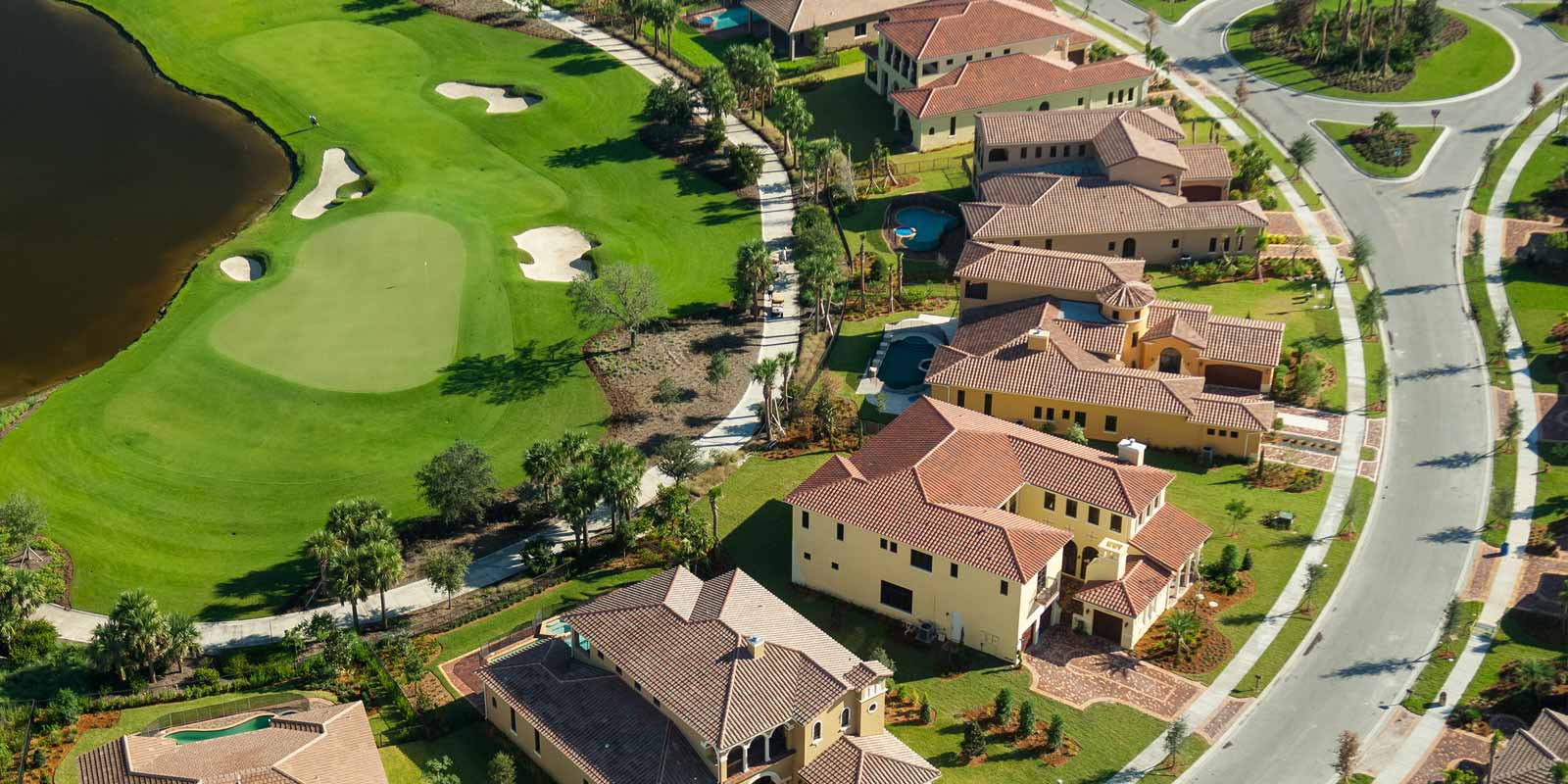 arial view of homes by golf course.